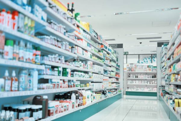 Cropped shot of fully stocked shelves in an aisle of a pharmacy Cropped shot of fully stocked shelves in an aisle of a pharmacy